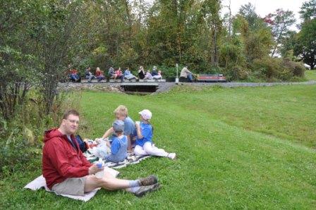 Enjoying a picnic snack and counting trains that go by