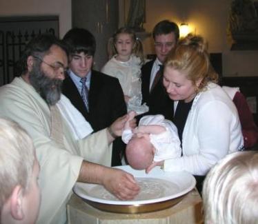 Deacon Claude baptizes Thomas