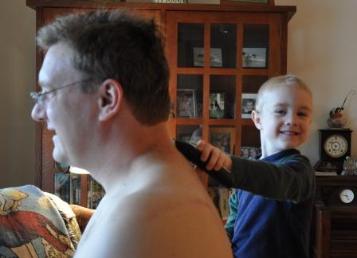 Thomas was promised a chance to trim Daddy's hair if he let Daddy clip his.