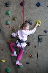 Bethan climbs a wall