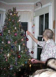 Maya lights candles on her tree