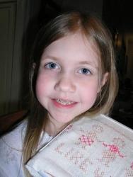 Bethan with braces and her new cross-stitch