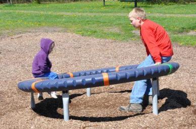 Enjoying the modern day playground merry-go-round