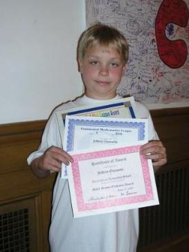 Jeffery with three of the awards he received at the 4th grade ceremony.
