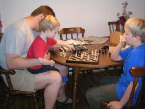 Thomas helping Daddy with a chess move
