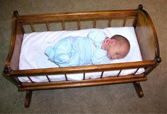 Thomas at 3 weeks in 23 inch baby doll cradle that Grandpa Bender made