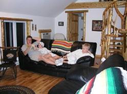 Ron reads Little House book at Gnall's guest apartment. Kids with Laddy