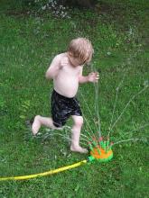 Enjoying his new sprinkler.