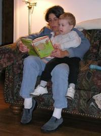 Thomas enjoys a favorite book with Jenny