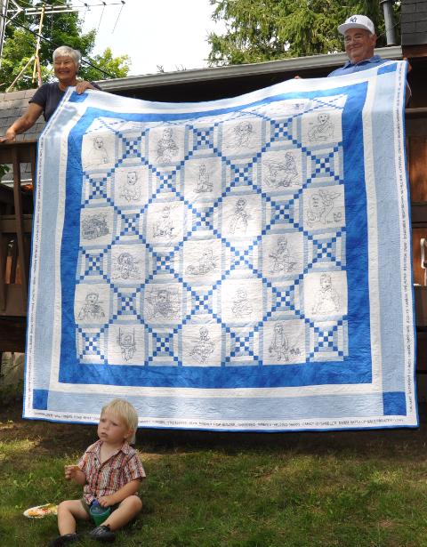 Aunt Susie embroidered baby photos of the 22 family members into this quilt and then bordered it with words around the edge.