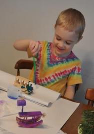 Thomas paints ornaments for Christmas