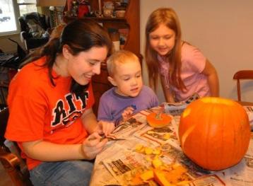 Thomas inspecting Lindsey's pumpkin