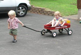Elias gives Thomas a ride in the Radio Flyer