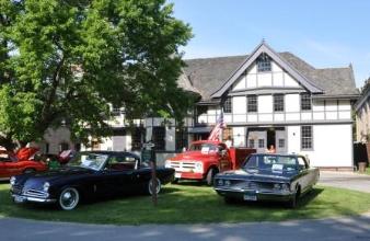 All three vehicles in front of the carriage house